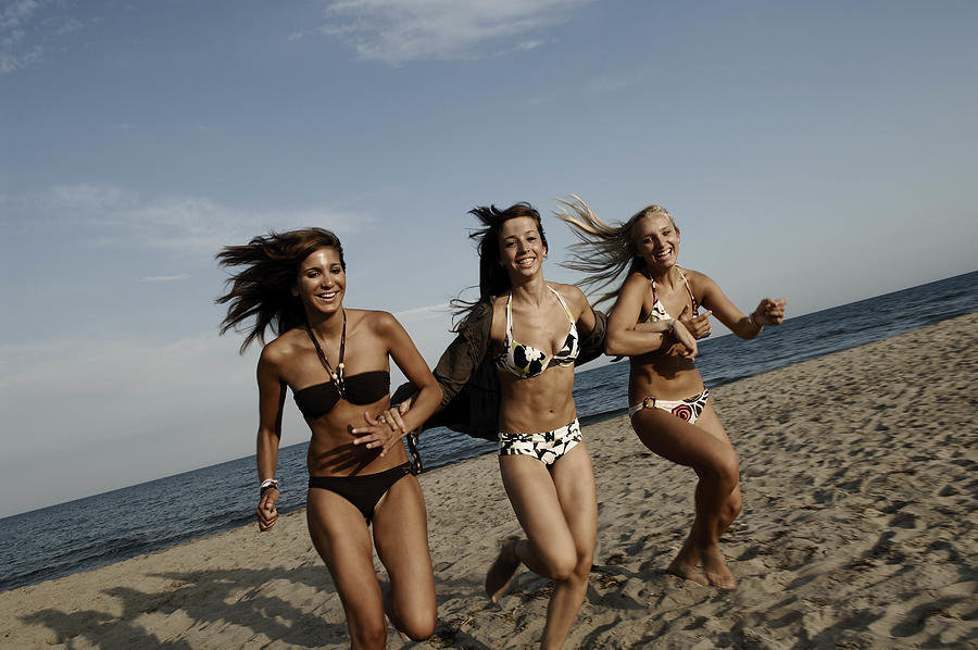 Girl teenagers running on the beach Photograph by Carol Kohen