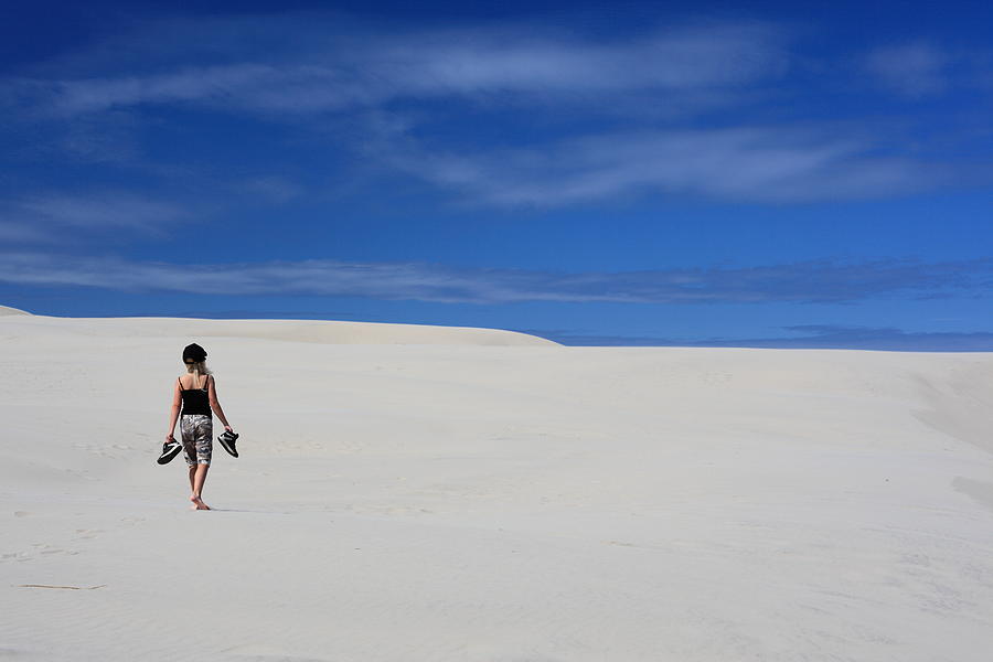 Girl walking in sand dunes / desert Photograph by Pejft