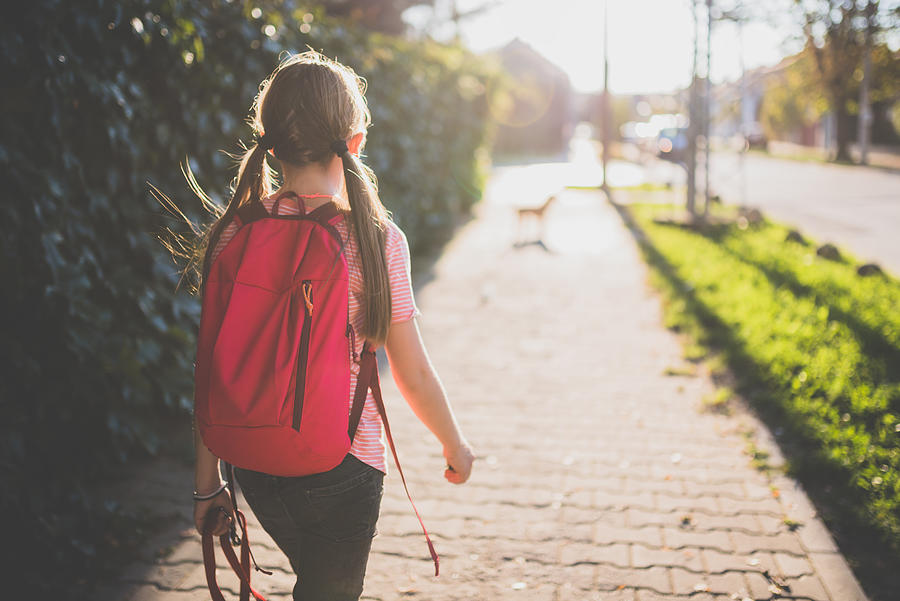 Girl walking to school Photograph by Kerkez