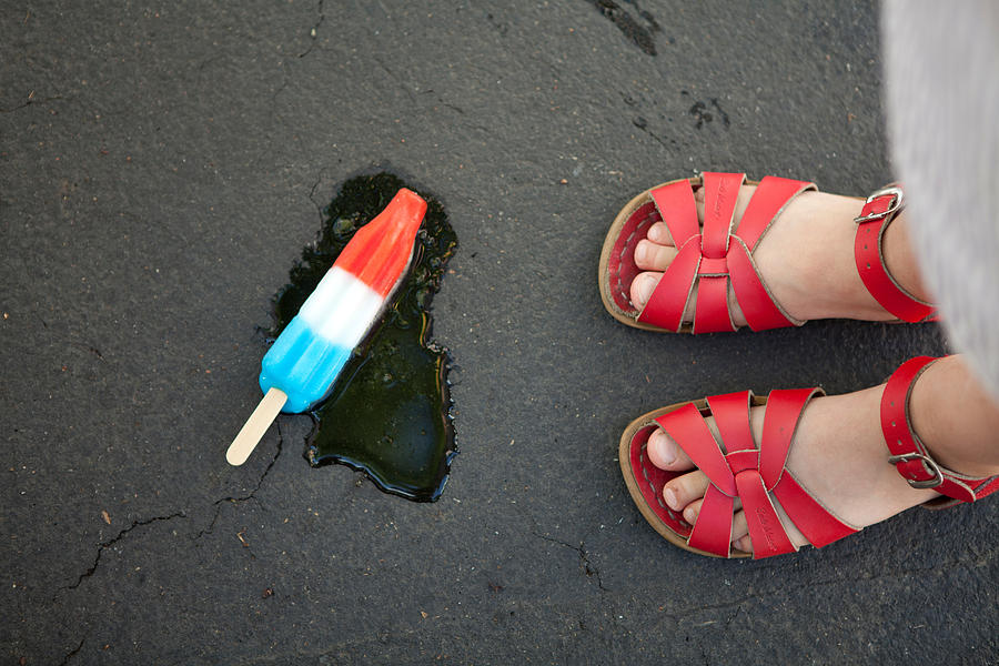 Girl wearing red sandals with ice lolly on floor Photograph by Flynn Larsen Girl wearing red sandals with ice lolly on floor Photograph by Flynn Larsen