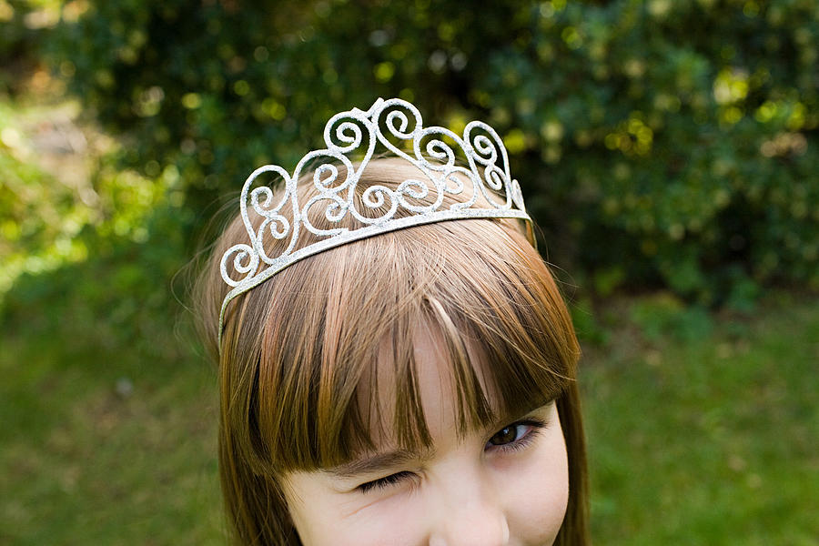 Girl wearing tiara and winking Photograph by Image Source