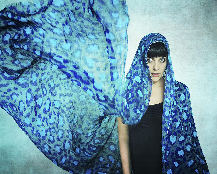 Girl with a blue scarf over her head flying Photograph by Graciela Vilagudin