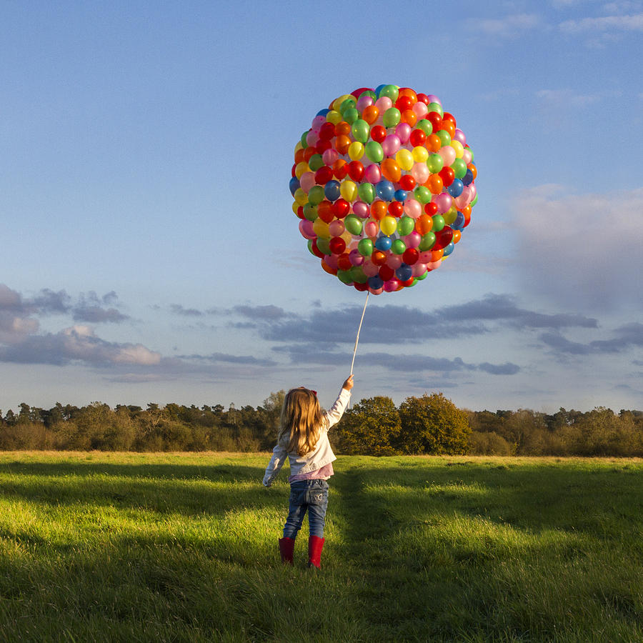 Girl with balloons in meadow Photograph by Thegoodly