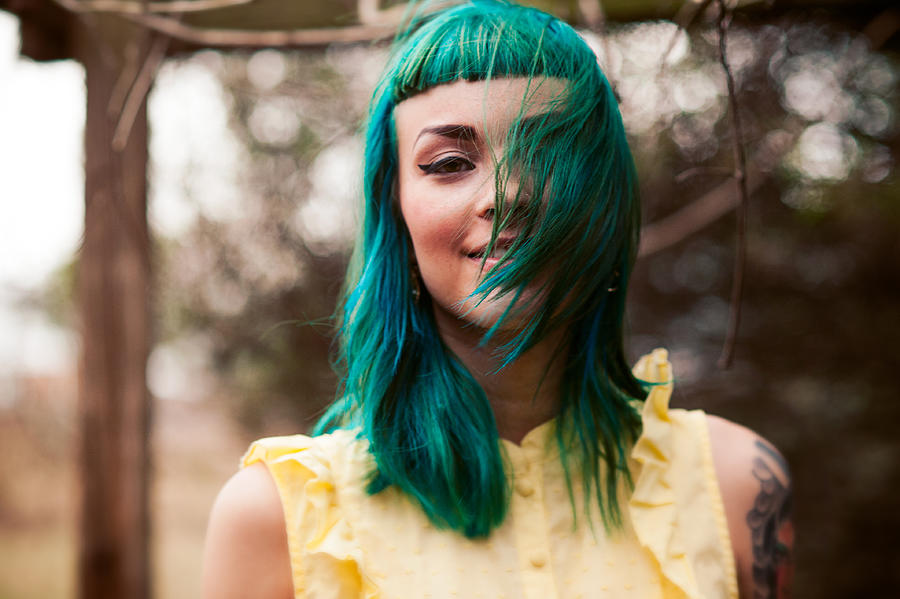 Girl with green hair blowing over her face Photograph by Marie Killen
