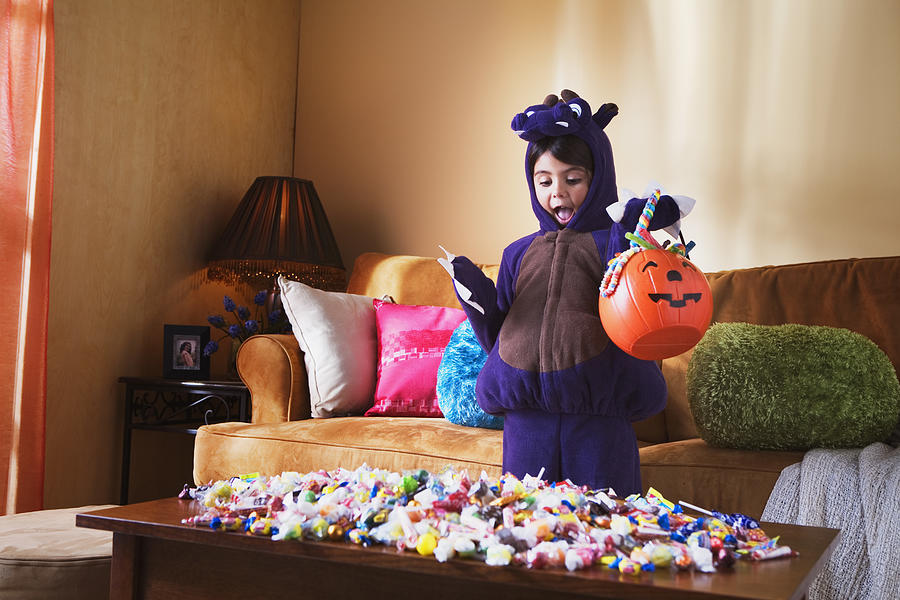 Girl with Halloween candy Photograph by Jupiterimages