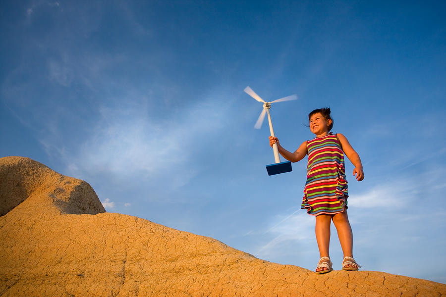 Girl with miniature wind turbine Photograph by Iantfoto