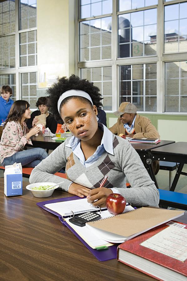 Girl working by herself in cafeteria Photograph by Image Source