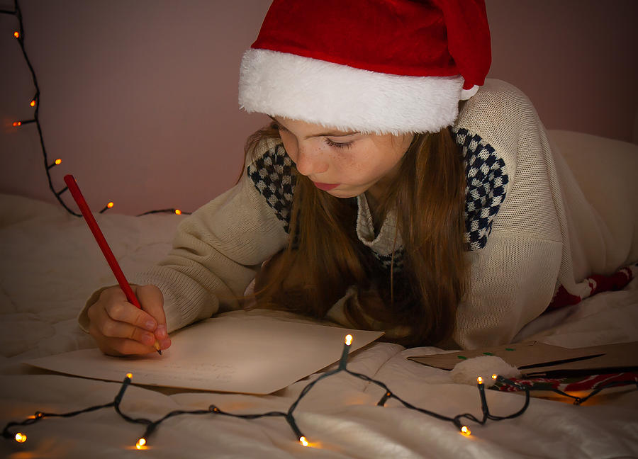 Girl writes a letter to Santa Claus. Photograph by Maryna Petrenko-Shvets