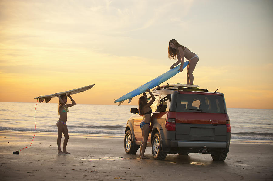 Girls At Beach Putting Surfboards On Car Top Photograph by Stephen Simpson