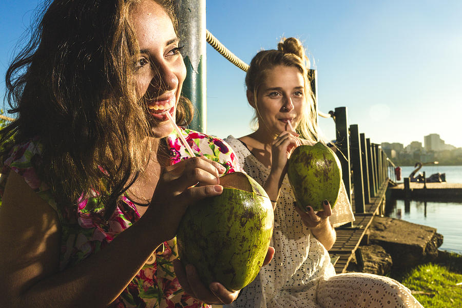 Girls drinking coconut water Photograph by Cesar Okada