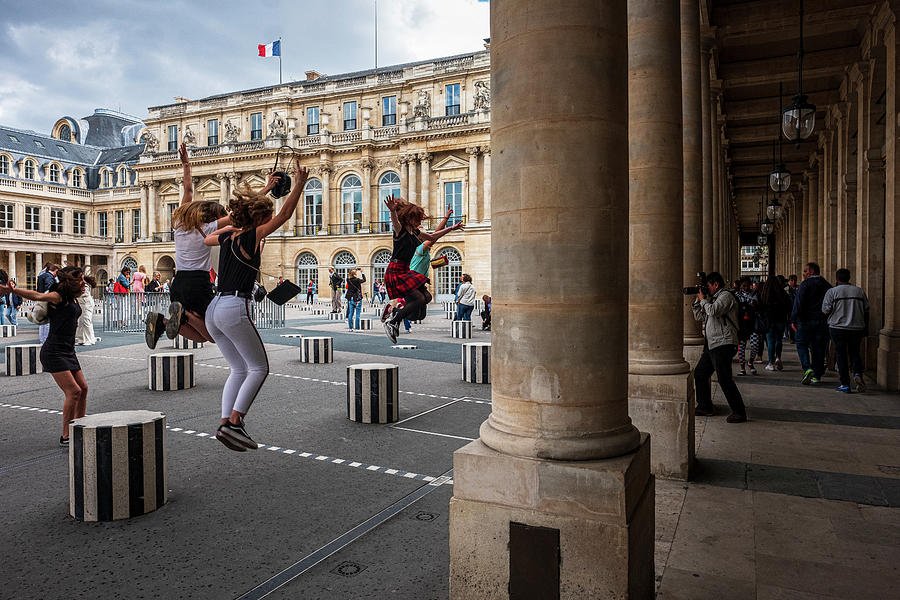 Girls jumping from Daniel Buren striped columns at Domain Nation Photograph by Ruben Vicente