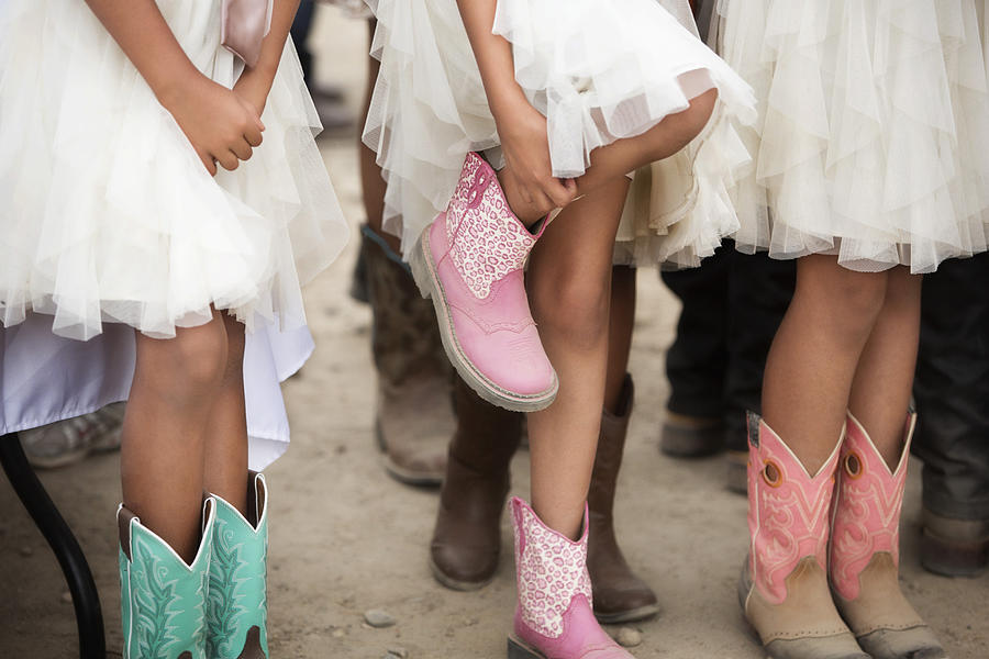 Girls wearing dresses and cowboy boots at quinceanera Photograph by Hill Street Studios