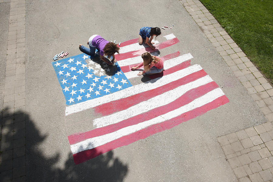 Girls with chalk coloring American flag on sidewalk Photograph by LWA/Dann Tardif
