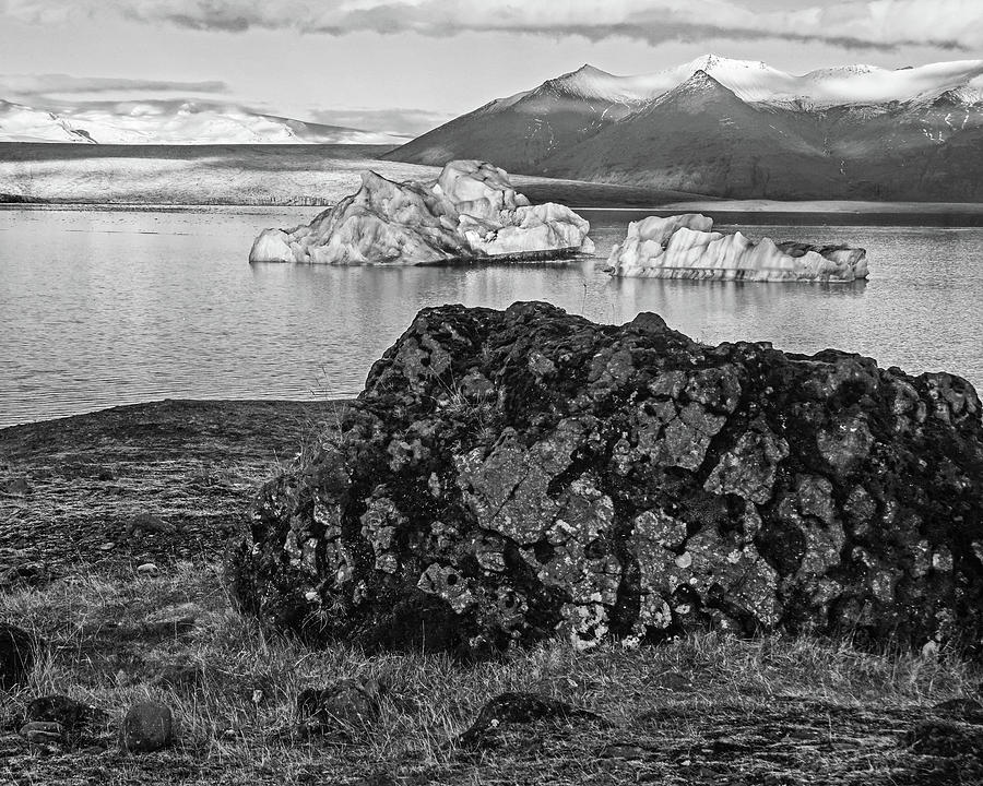 Glacier Lagoon Black Rock and Large Blue Iceberg Jokulsarlon Iceland Black and White Photograph by Toby McGuire
