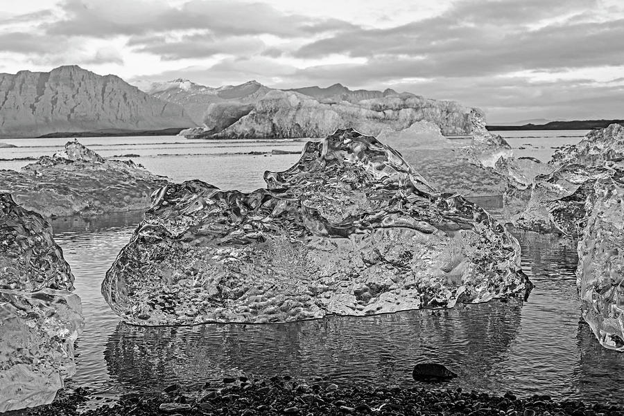 Glacier Lagoon Clear Ice Chunk and Large Blue Iceberg Jokulsarlon Iceland Black and White Photograph by Toby McGuire