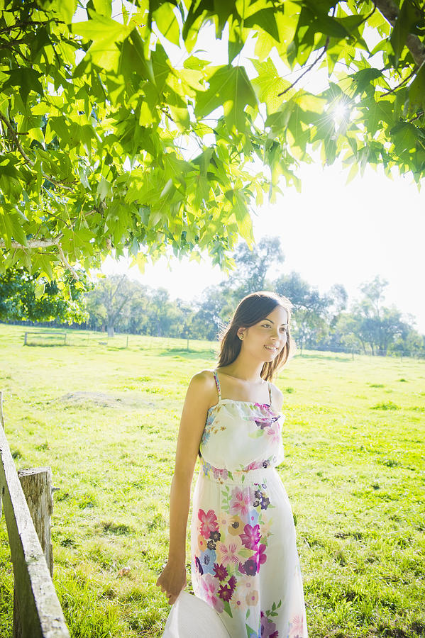 Glamorous Hispanic woman standing in park Photograph by Jacobs Stock Photography Ltd