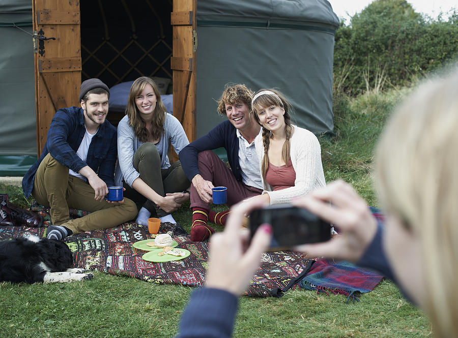 Glamping friends on rug posing for photograph. Photograph by Mike Harrington