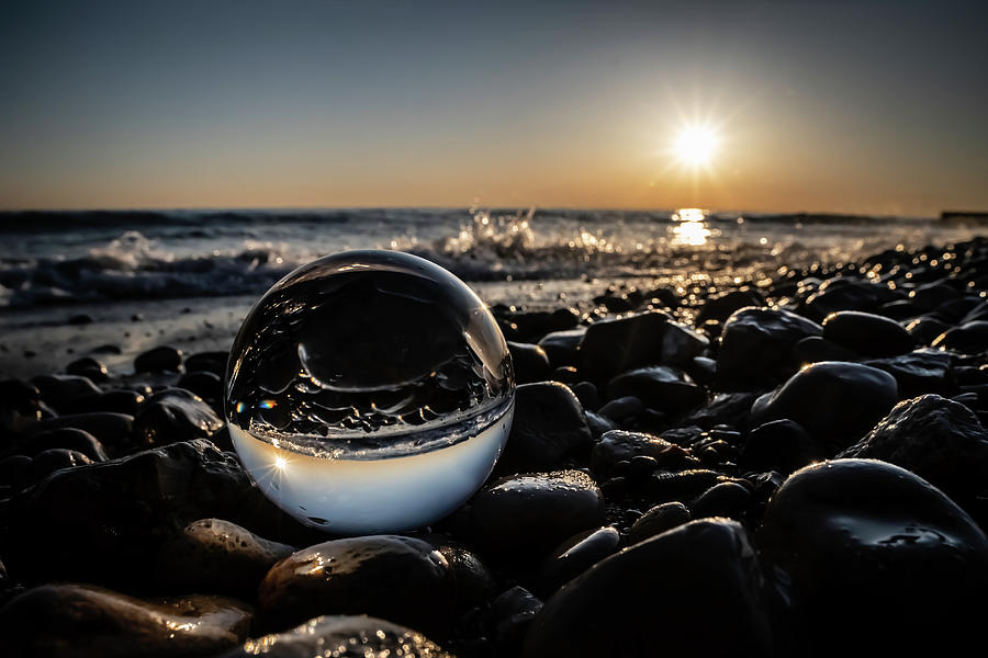 Glass Ball at beach sun rise scene by Sven Brogren
