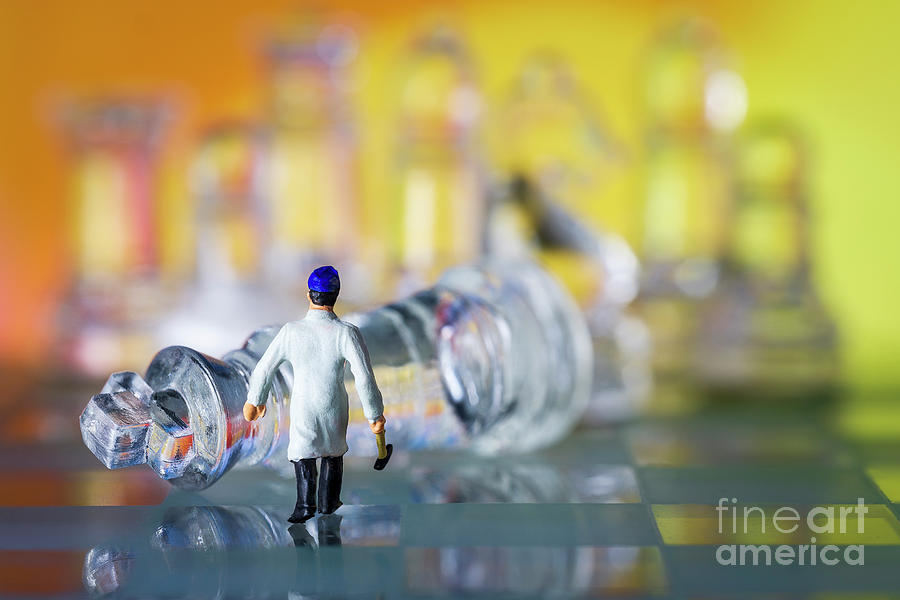 Glass chess board and pieces. Miniature man with hammer walking towards fallen king warm background macro Photograph by Pablo Avanzini