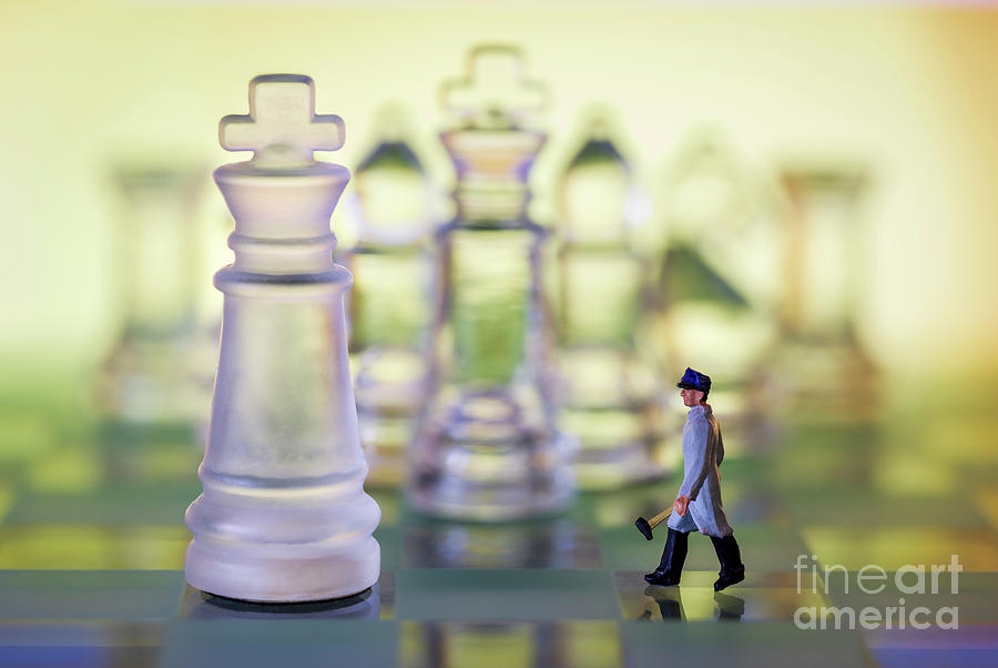 Glass chess board and pieces. Miniature man with hammer walking towards king warm background macro Photograph by Pablo Avanzini