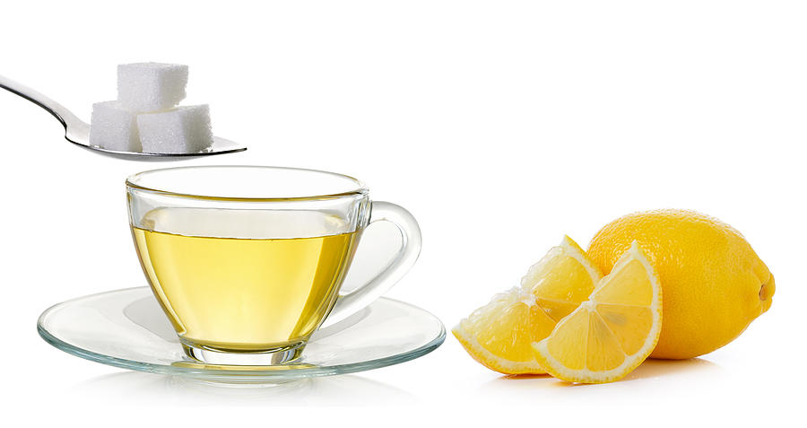 Glass cup of  lemon tea and sugar isolated Photograph by Sommail