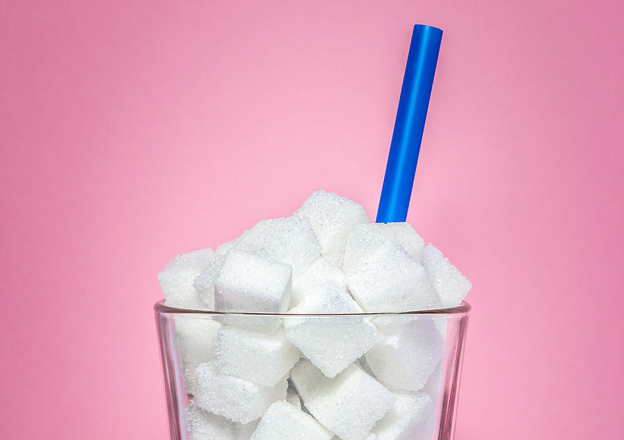 Glass full of sugar cubes - unhealthy diet concept. Photograph by weiXx