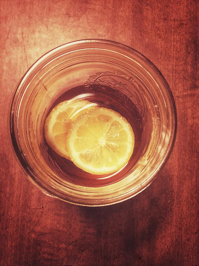 Glass Half Full Of Ice Tea With Lemon Slices Photograph