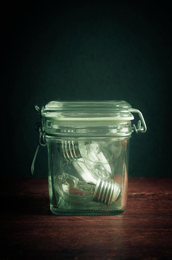 Glass Jar and Light Bulbs Photograph by Carlos Caetano