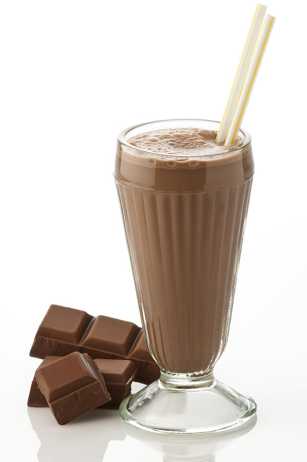 Glass of chocolate milkshake with chocolate chunks on white Photograph by Fcafotodigital