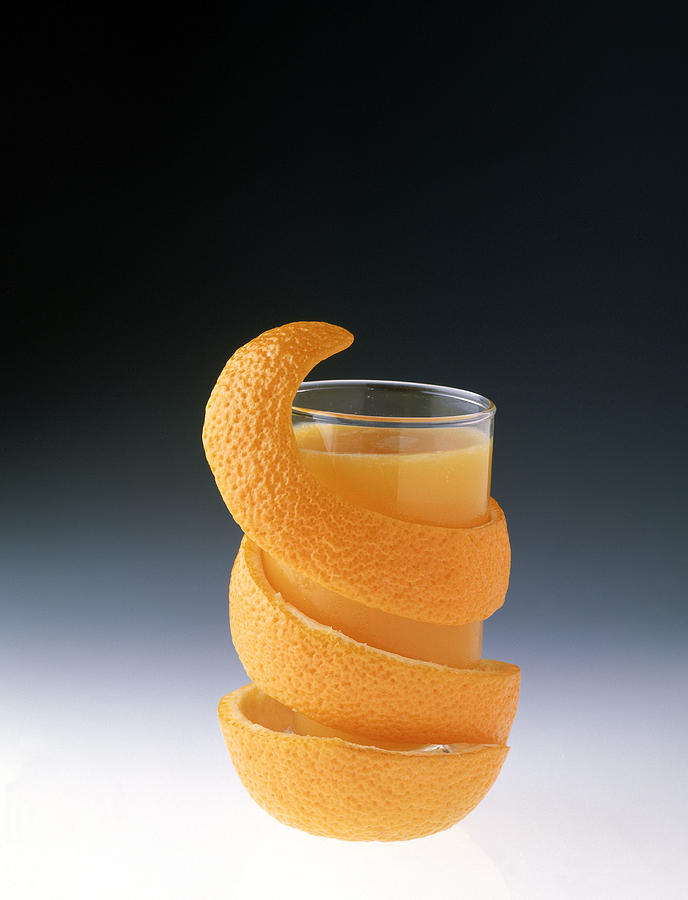 Glass of orange juice with orange peel Photograph by Jackson Vereen