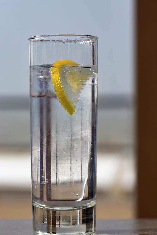 Glass of tonic water with a slice of lemon Photograph by Sebastian Radu