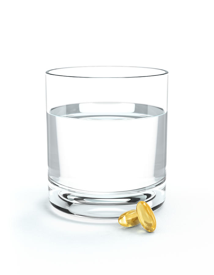 Glass of water and oil supplements Photograph by I Like That One