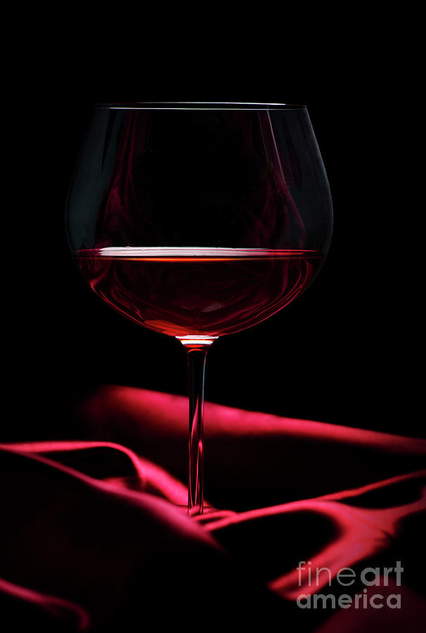 Glass of wine on red silk Photograph by Jelena Jovanovic