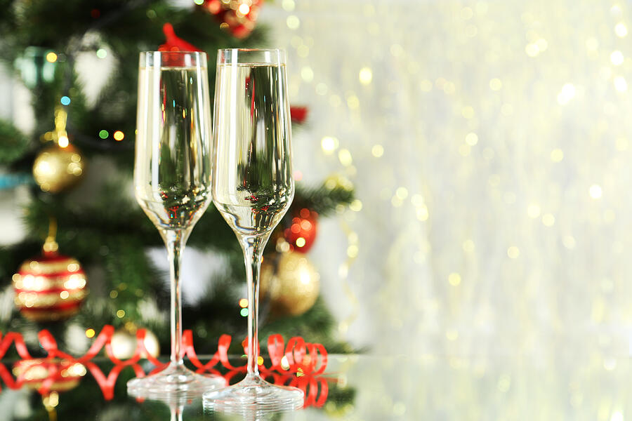 Glasses of champagne on a lights background Photograph by 5second