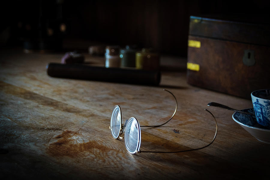Glasses Rest on an Old Desk Photograph by John Twynam