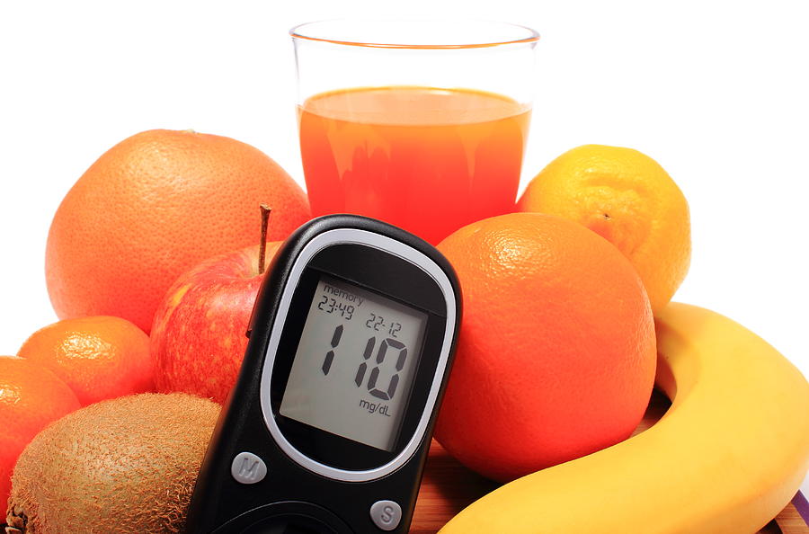 Glucometer, fresh natural fruits and glass of juice Photograph by Ratmaner