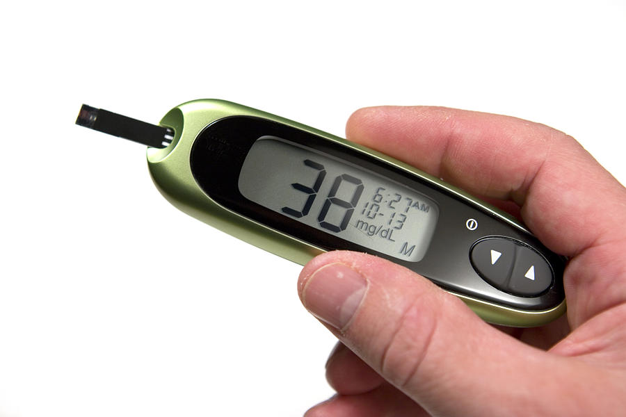 Glucose monitor displaying 38mg/dL being held by a person Photograph by MarkHatfield