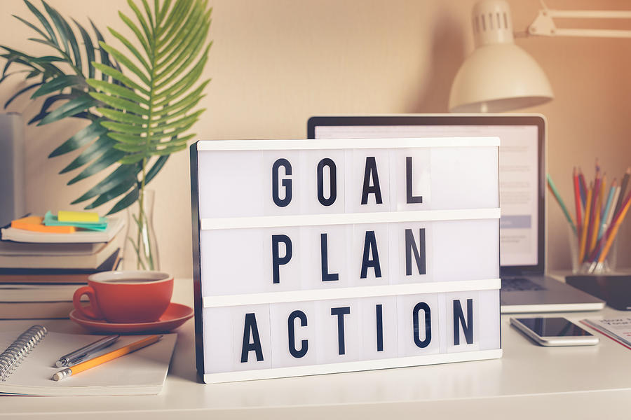 Goal,plan,action text on light box on desk table in home office Photograph by Hakinmhan