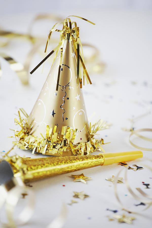 Gold Colored Party Hat and Noisemaker Photograph by Tammy Hanratty