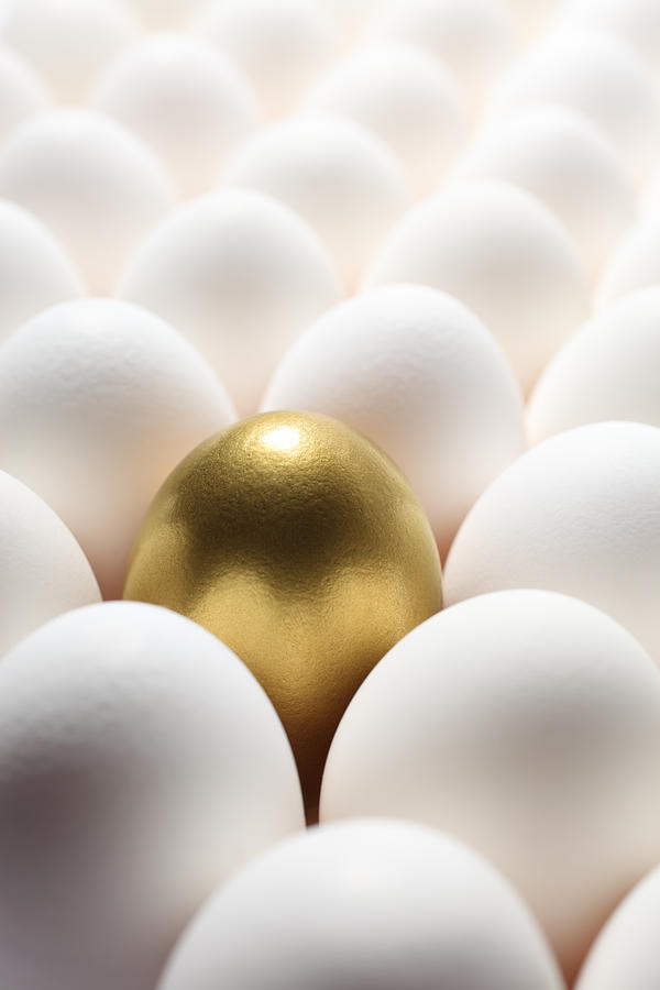 Gold Egg in the Middle of Many Regular Eggs Photograph by Blackred