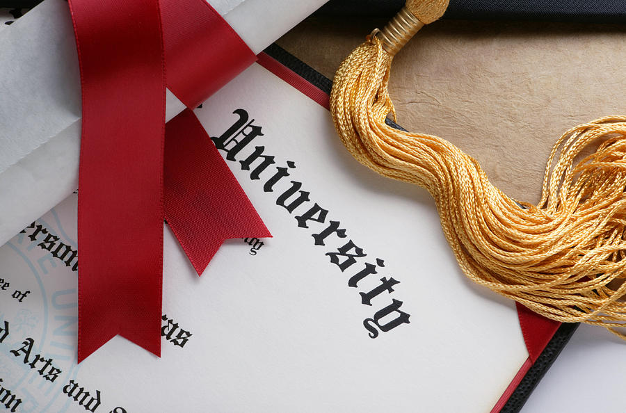Gold tassel and rolled diploma with red ribbon Photograph by Dny59