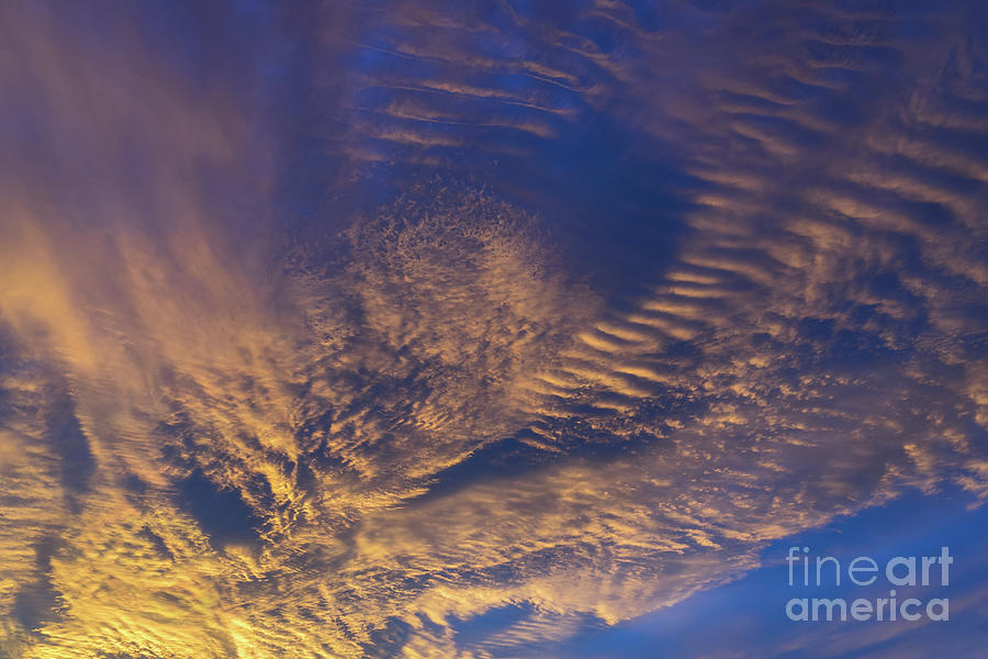 Golden and dark blue cloudscape at sunset Photograph by Adriana Mueller