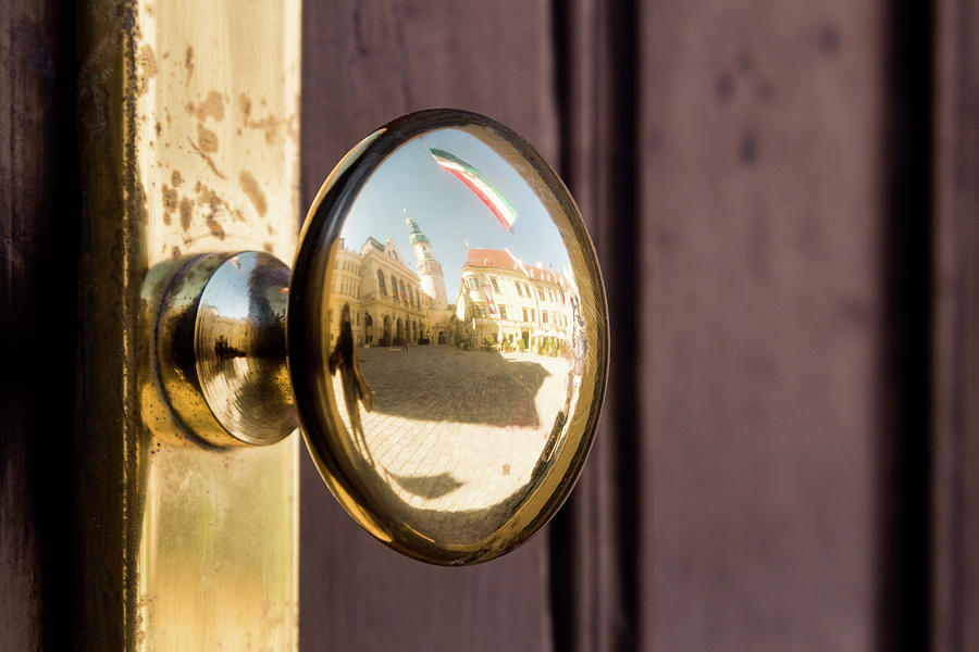Golden doorknob reflecting the historical inner town of Sopron Photograph by Viktor Wallon-Hars