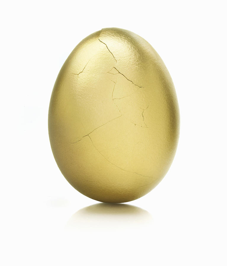 Golden egg, cracks on surface, close up Photograph by Lauren Nicole