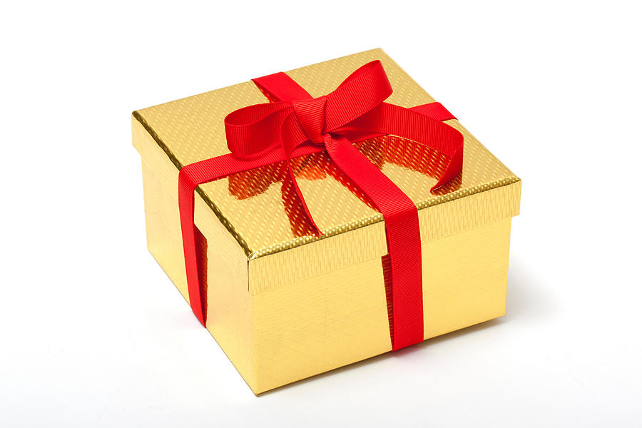 Golden gift box with red ribbon Photograph by Image Source