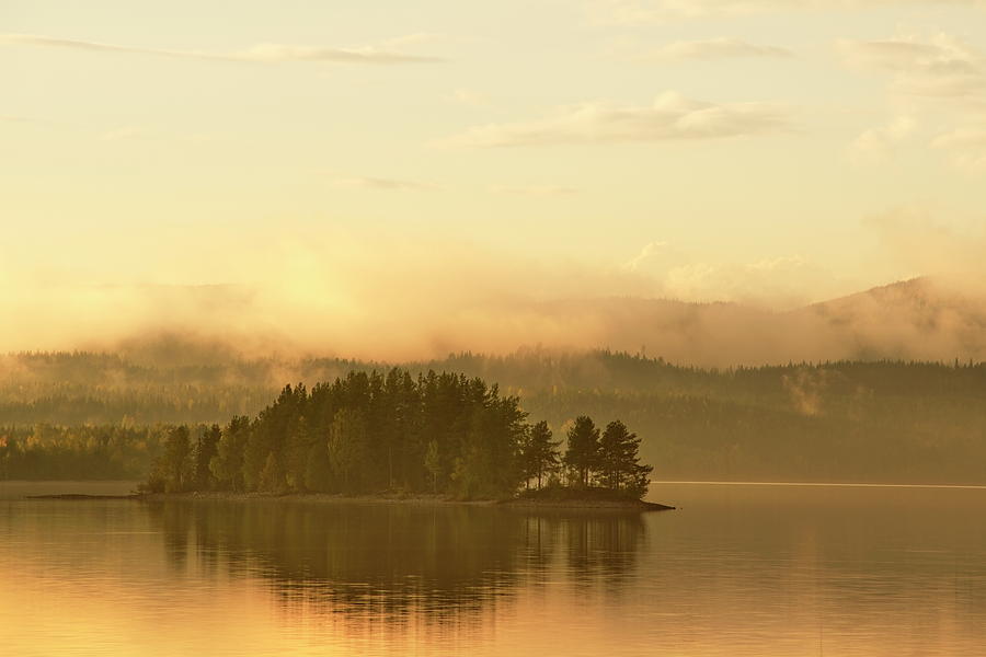 Golden haze is rising over a tiny wooded island in a glassy lake Photograph by Ulrich Kunst And Bettina Scheidulin