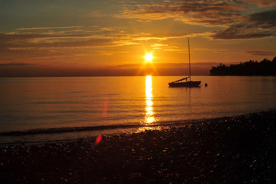 Golden sunrise over the sailboat Photograph by Steve Schwarz