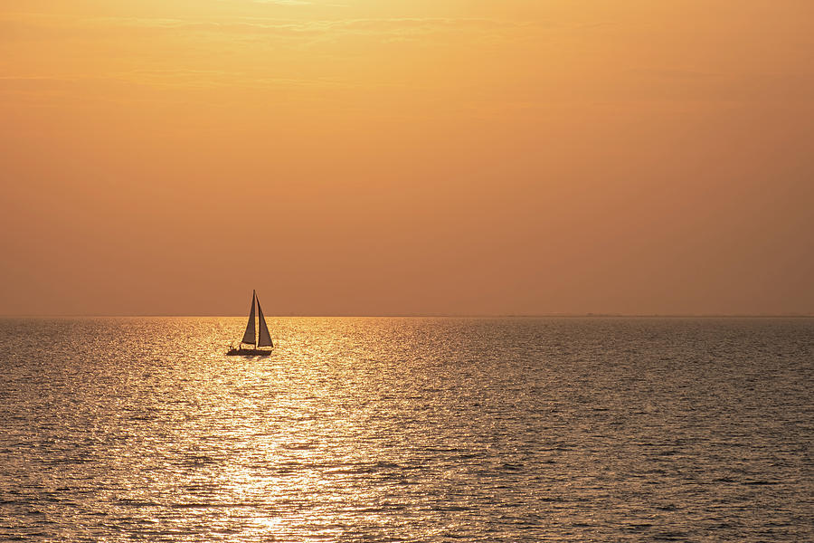 Golden Sunset Seascape with a Sailboat in the middle of the Sea Photograph by Alexios Ntounas