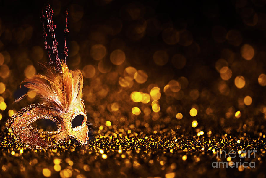 Golden venetian mask on dark godlen bokeh background. New year a