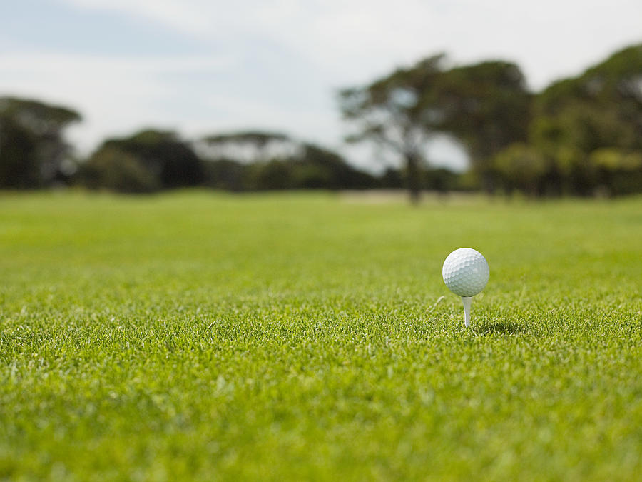 Golf ball on golf course, close up Photograph by Image Source